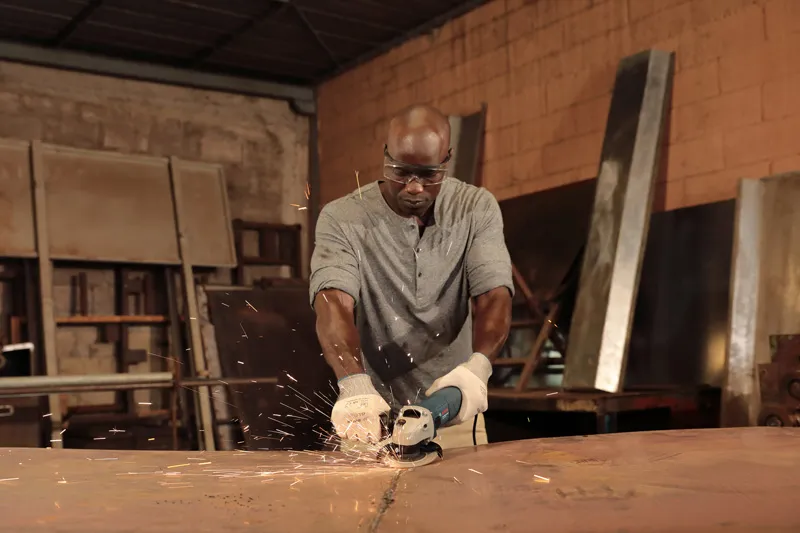 Man grinding metal sparks.