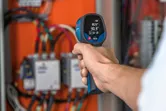 Infrared thermometer checks panel.