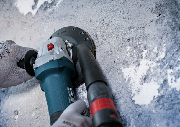 Bosch dust extraction guard for angle grinder on concrete.